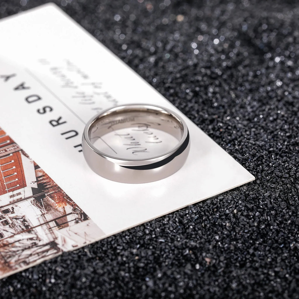 Silver titanium steel ring with grinding finish on finger, showing smooth surface and uniform colour