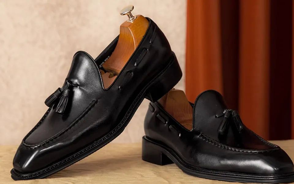 Men's black genuine leather fringed slip-on loafers with rubber soles and British styling