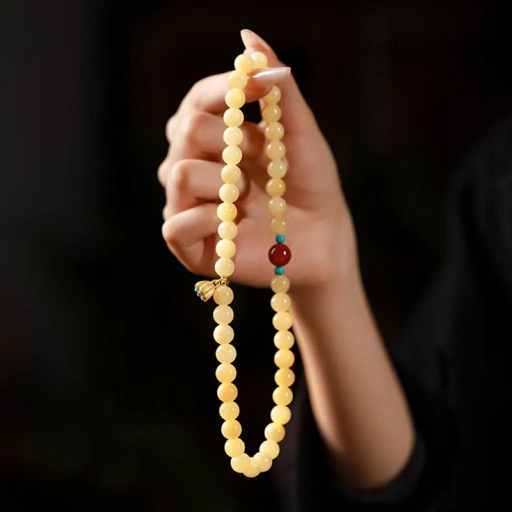 Hand-woven yellow topaz double ring bracelet with lotus seedpod beads for women.