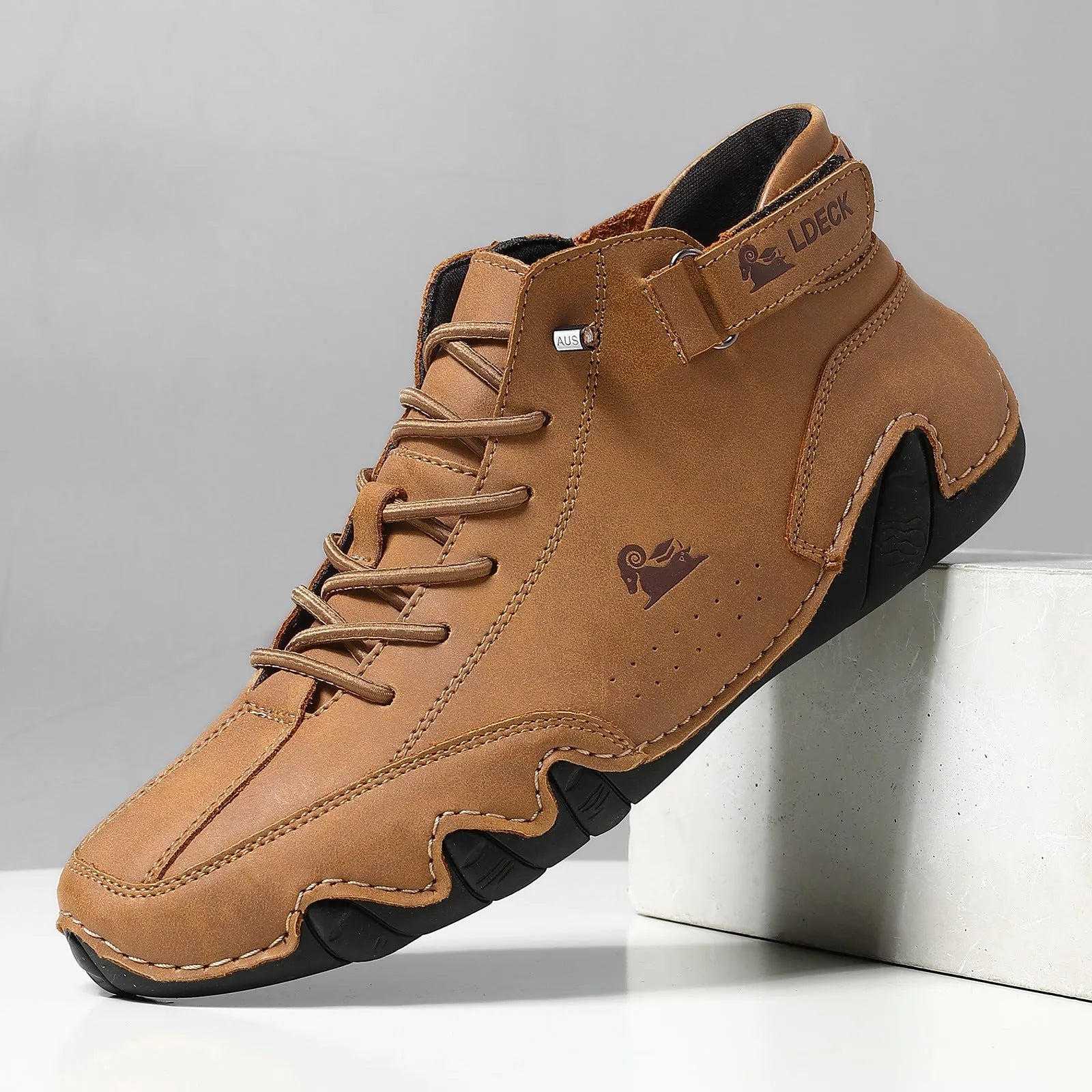 High top men's shoes in khaki with rubber soles and microfiber uppers, showing round toe and pigskin boot tube