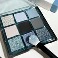 MUGELEEN nine-colour eye shadow palette showing low saturation ice permeable blue and smoked shades with matte and shimmer textures