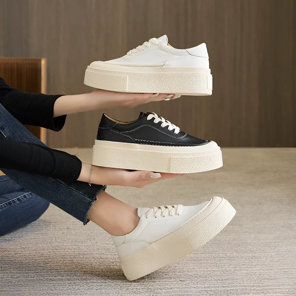 Women's black embossed cowhide leather platform sports shoes with white rubber sole and lace-up front.