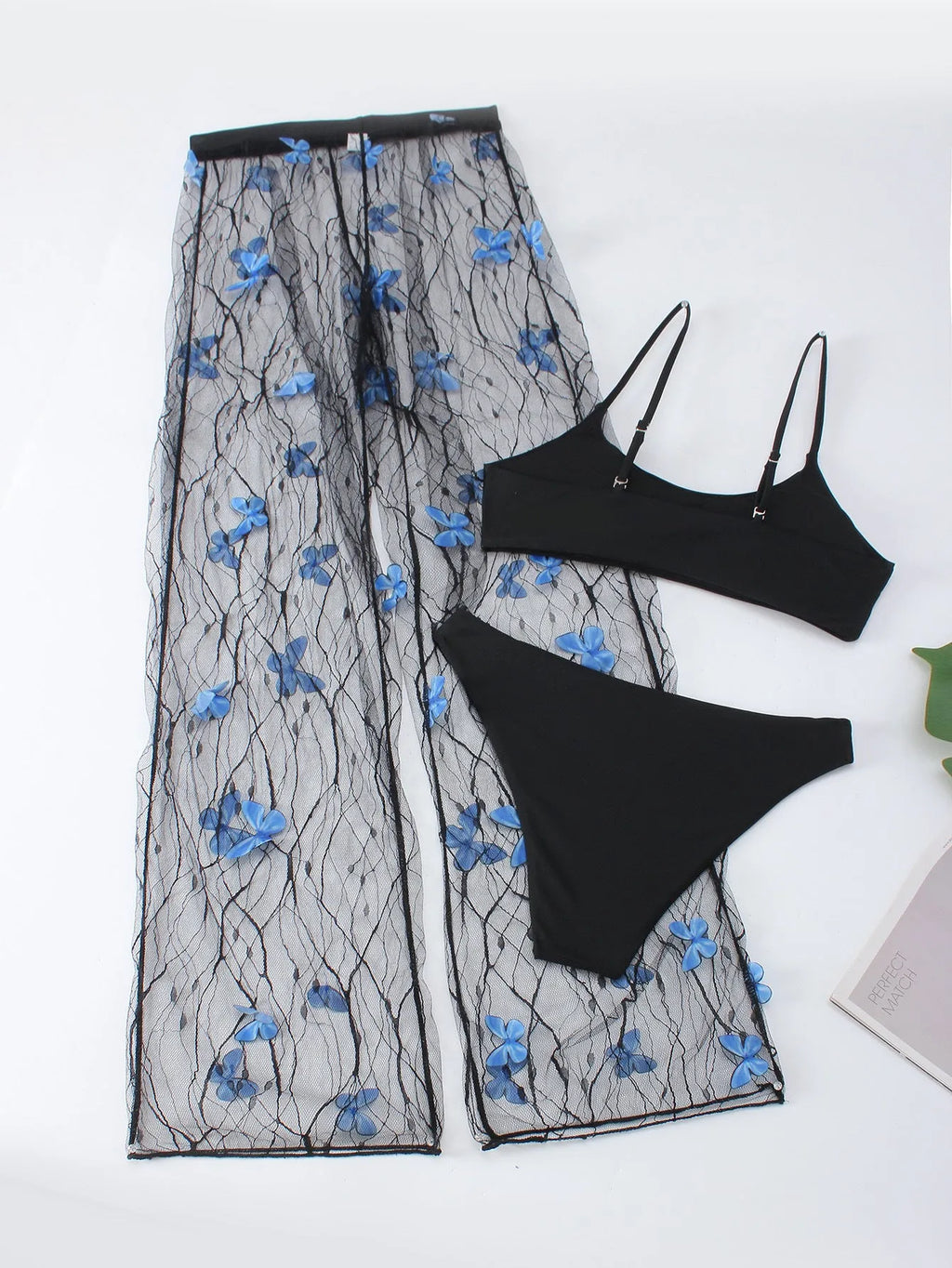 Black women's bikini set with butterfly embroidery showing top, underwear and pants pieces