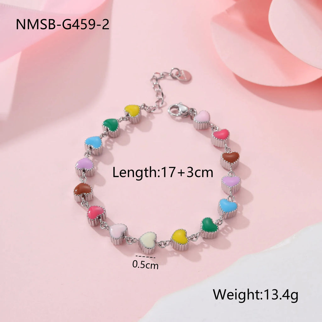 Gold and steel colour heart-shaped titanium steel bracelet on a model's wrist.