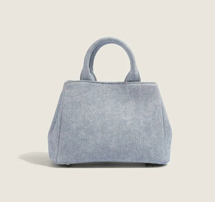 Women's casual shoulder bag in denim blue or white colour made from soft PU material