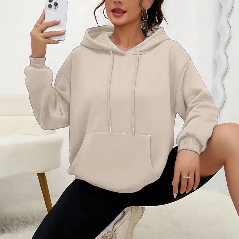 Women's loose grey sweatshirt with long sleeves and a front drawstring pocket, shown in a relaxed fit.