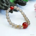 Natural smoky purple and red agate bracelet with 8mm geometric beads on a wrist.