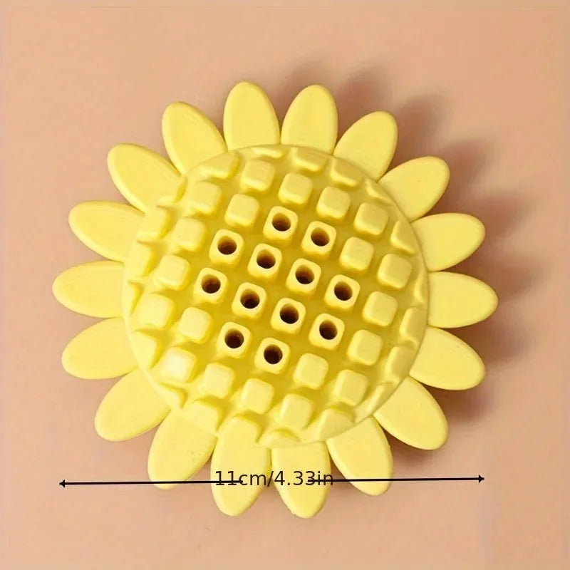Yellow rubber sunflower-shaped dog chew toy with textured petals.