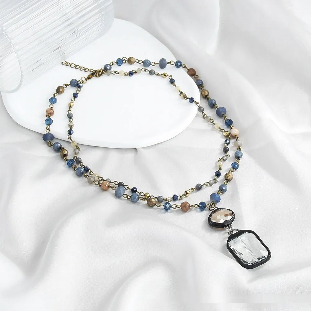 Two-layer tribal necklace with a stone and glass pendant on an alloy chain.