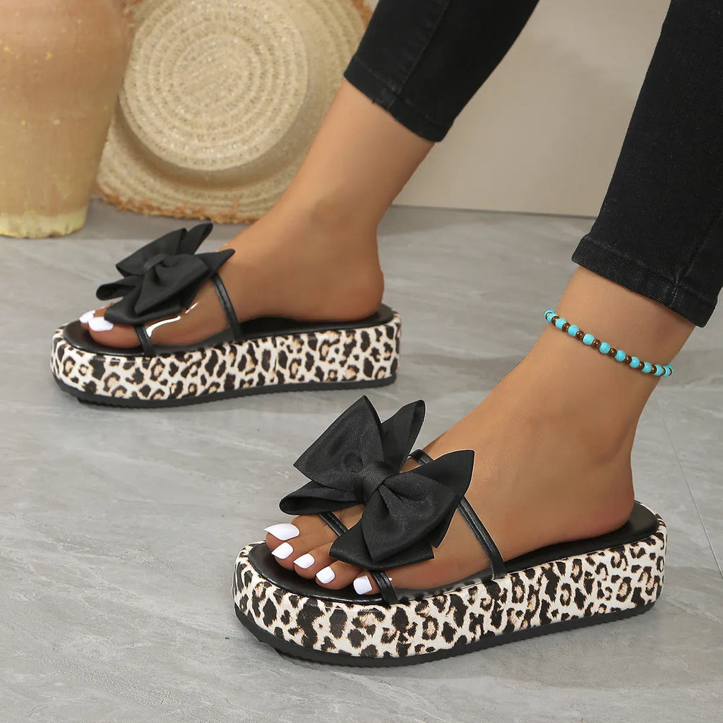 Women's leopard print beach slippers with thick sole and round toe in black and white options