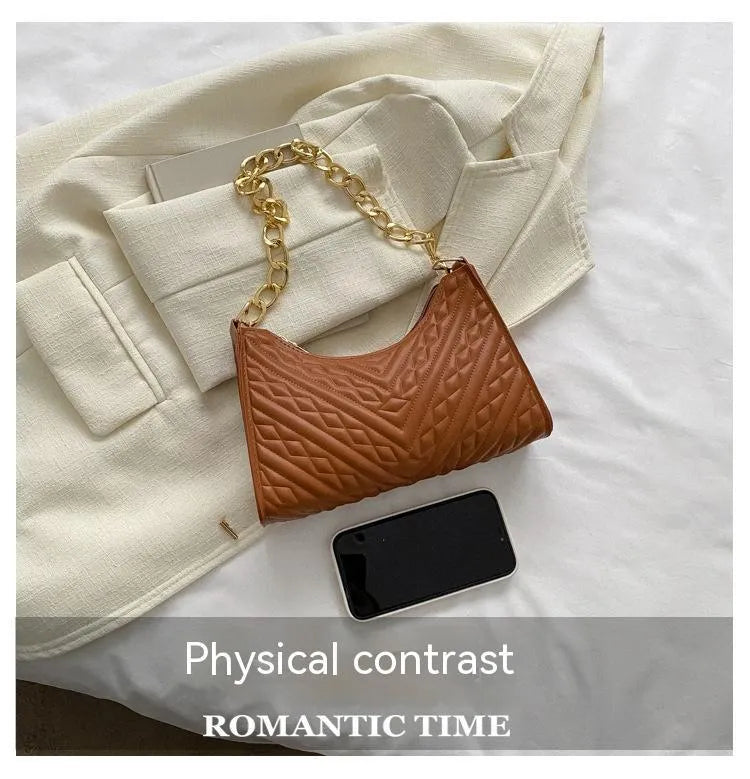 Brown pleated chain baguette shoulder bag with adjustable strap and soft carry handle showing three-dimensional pocket design