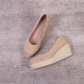 Women's apricot coloured wedge heel pumps with round toe and shallow mouth on a white background.