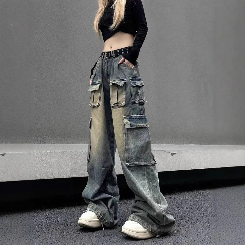 Man wearing light blue loose fit distressed jeans with multiple pockets and straight leg style.
