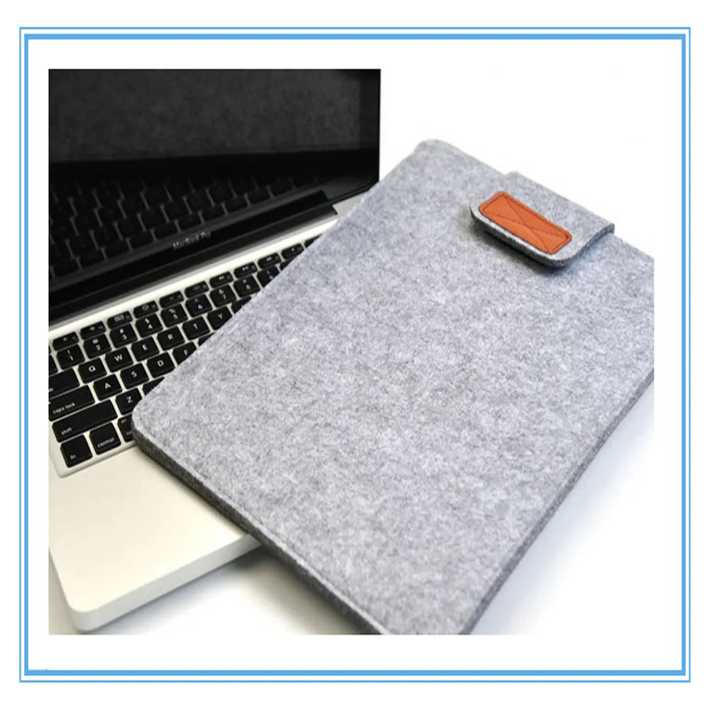 Dark grey clamshell laptop bag showing interior with polyester lining and corner protectors