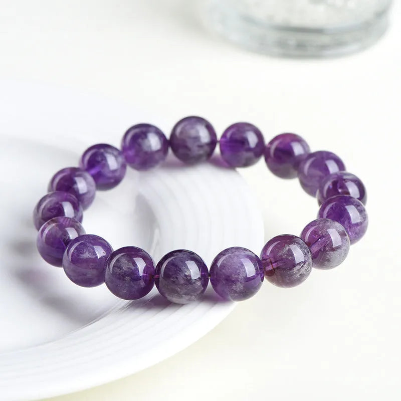 Natural feather amethyst crystal bracelet with scattered geometric beads showing purple crystal patterns and Ruyi elements