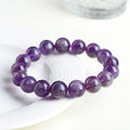Natural feather amethyst crystal bracelet with scattered geometric beads showing purple crystal patterns and Ruyi elements