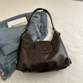 Textured PU leather women's single strap shoulder bag in a horizontal square shape, shown in black colour.