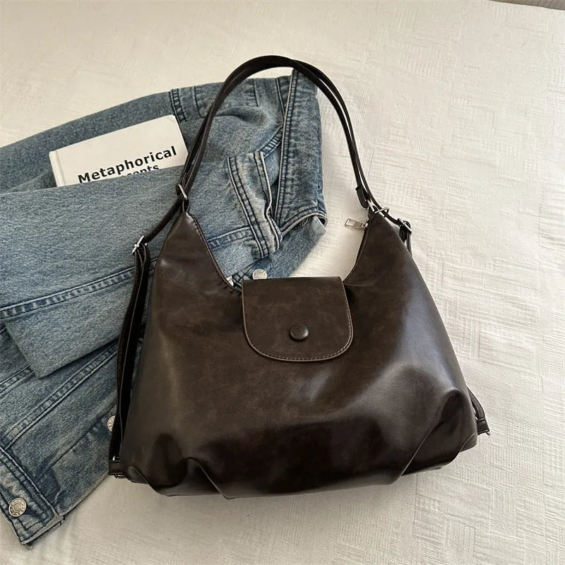 Textured PU leather women's single strap shoulder bag in a horizontal square shape, shown in black colour.