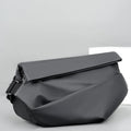 Men's grey crossbody bag with motorcycle sling strap, horizontal square shape, and zipper opening
