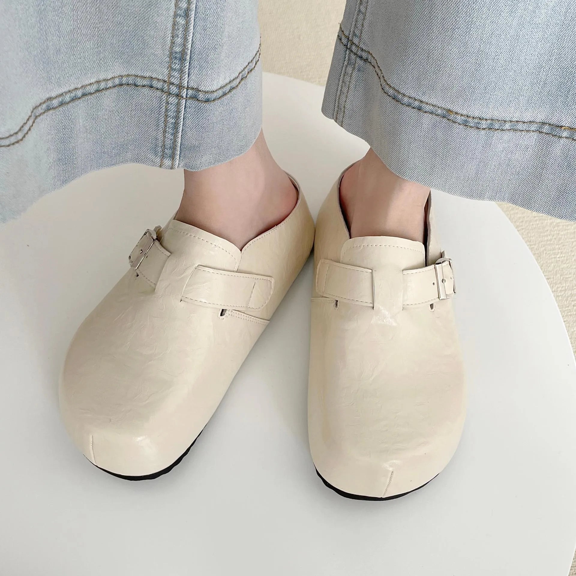 Flat buckle casual sneakers in yellow, creamy-white, silver, and black colours, showing round toe and PU upper.