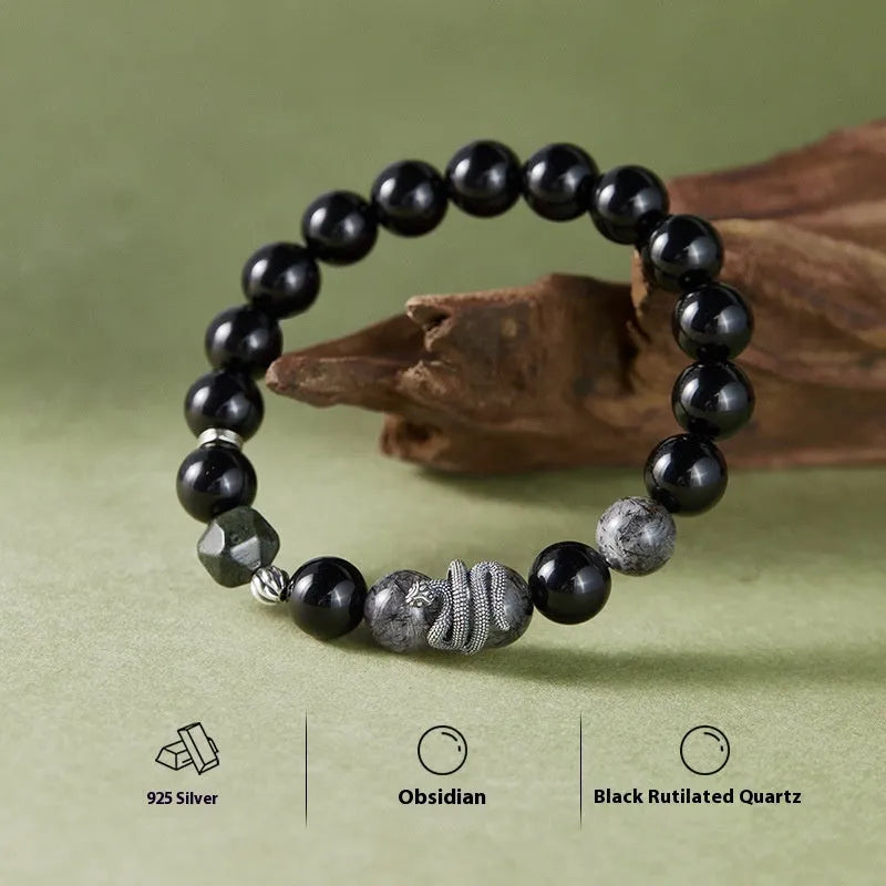 Men's retro snake bracelet in sterling silver with a large black obsidian stone on a dark background.