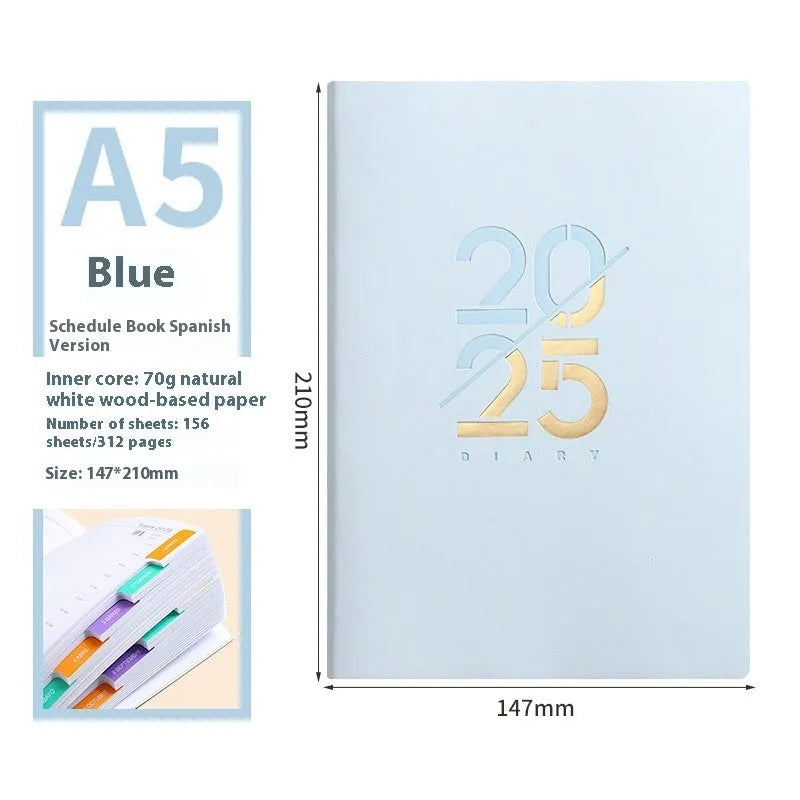 2025 A5 schedule book with faux leather cover in blue, showing open pages on a desk