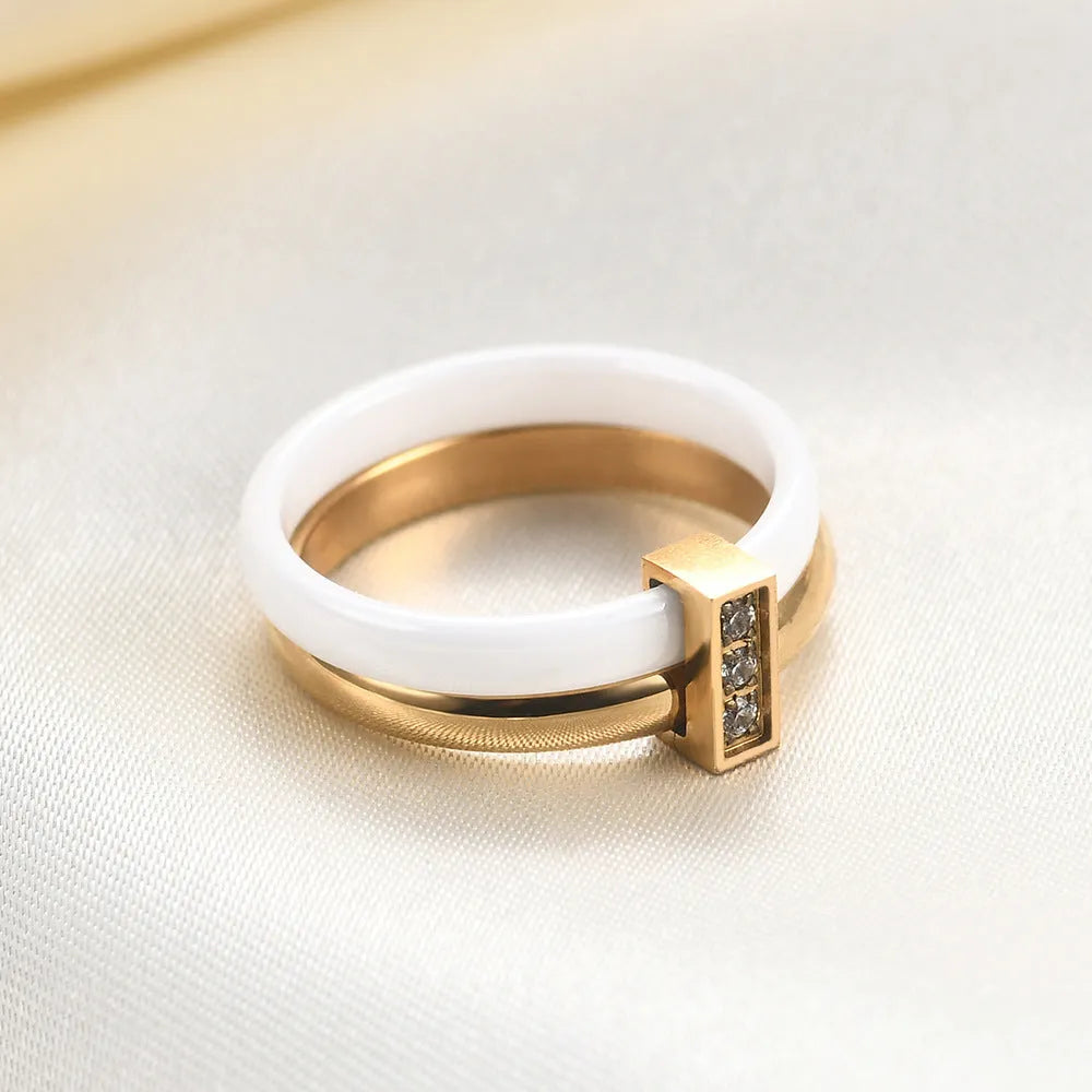 Geometric ceramic ring with zirconium inlay, available in steel black or gold white, sizes 6 to 10