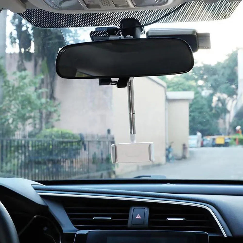 Black car phone holder mounted on rearview mirror with mobile phone secured in adjustable bracket