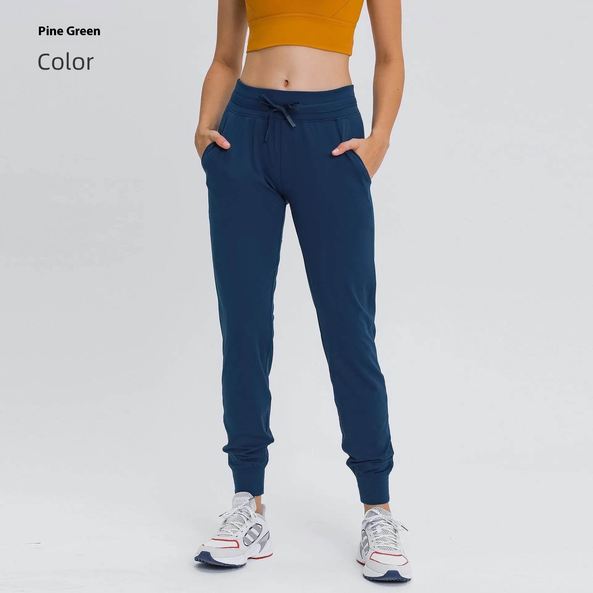 Women's high waist yoga pants with drawstring waistband in Belgian blue colour, showing elastic fit for exercise
