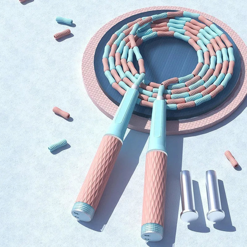 A children's skipping rope with soft bamboo-style beads, shown in a choice of blue, pink, green, and purple colours.