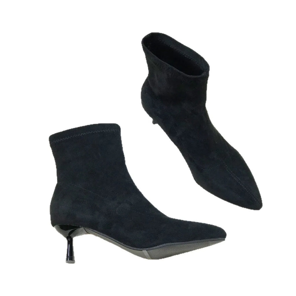 Women's black pointed toe ankle boots with a high stiletto heel on a microfiber upper.