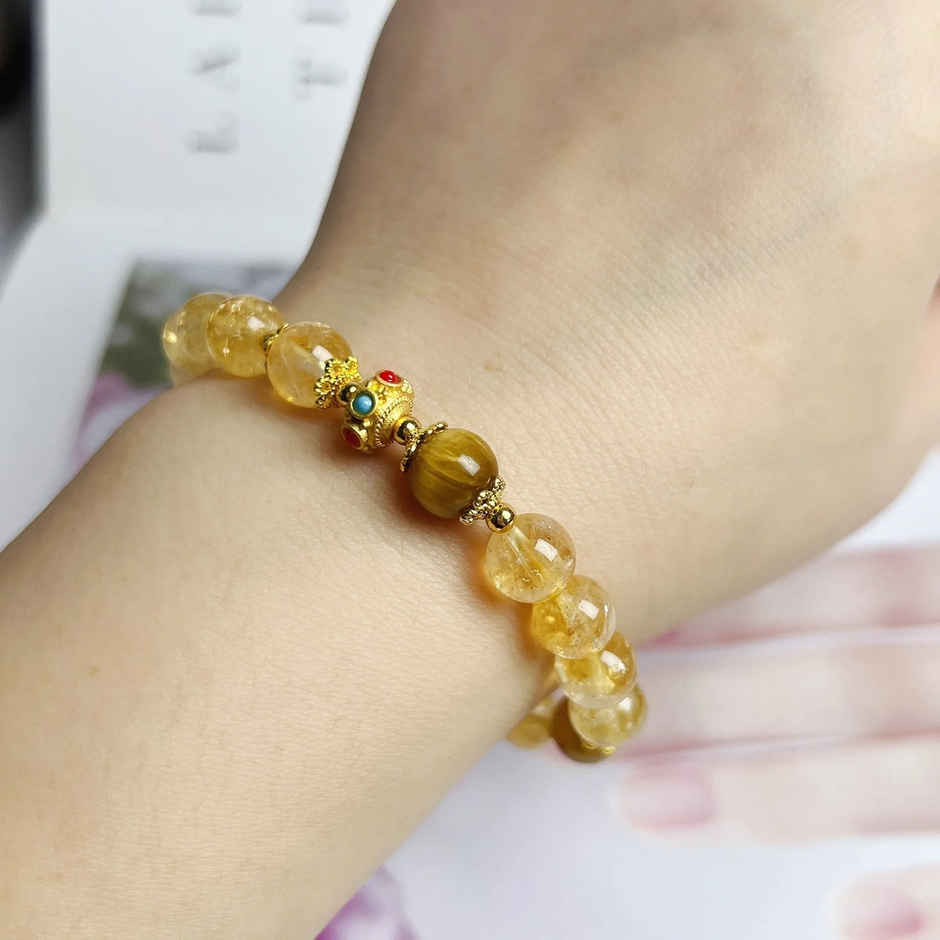 Handcrafted citrine crystal bracelet for women with a flower and tassel design.