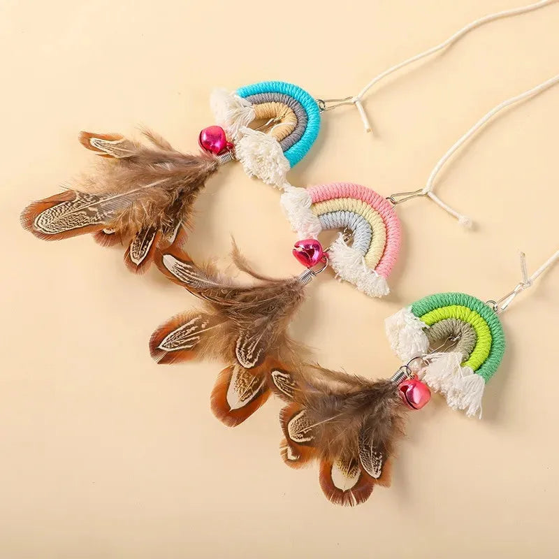 Blue feather cat rope hanging from a door on an elastic swing with a sticky buckle clamp.