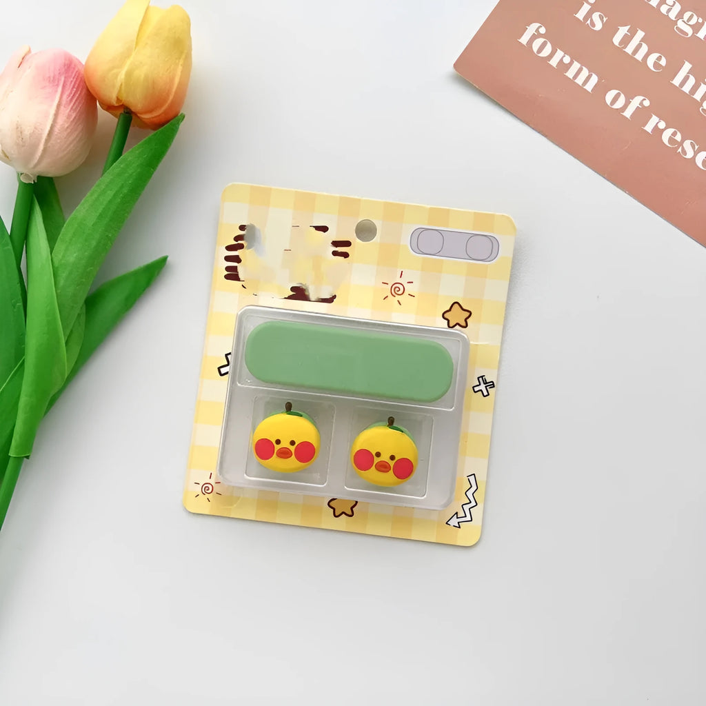 Cartoon-style magnetic plastic cable fixer clip in various colours on a metallic desk surface.