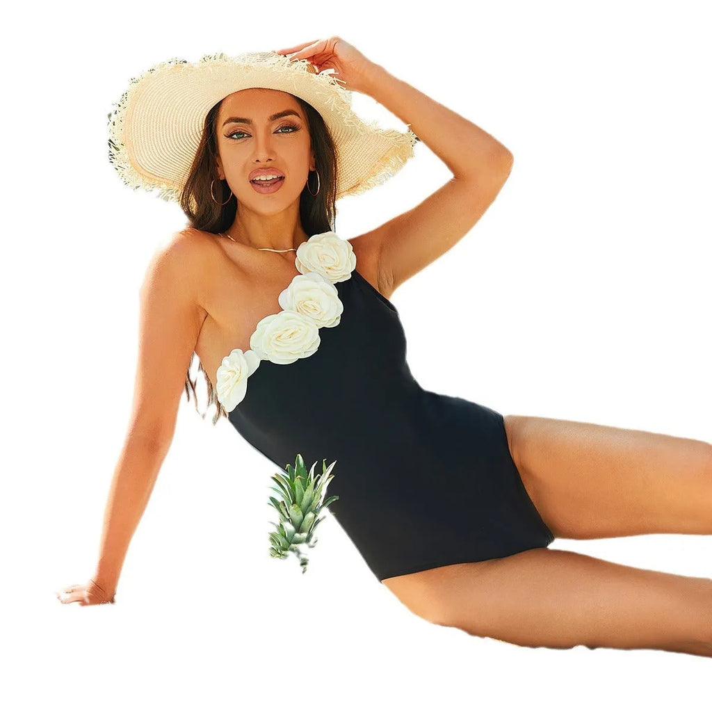 Black solid colour one-piece swimsuit for women on a hanger