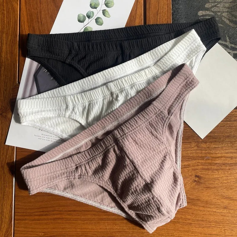 Men's triangle underwear in pure cotton with mid-waist design, available in skin colour, apricot, black, and white variations