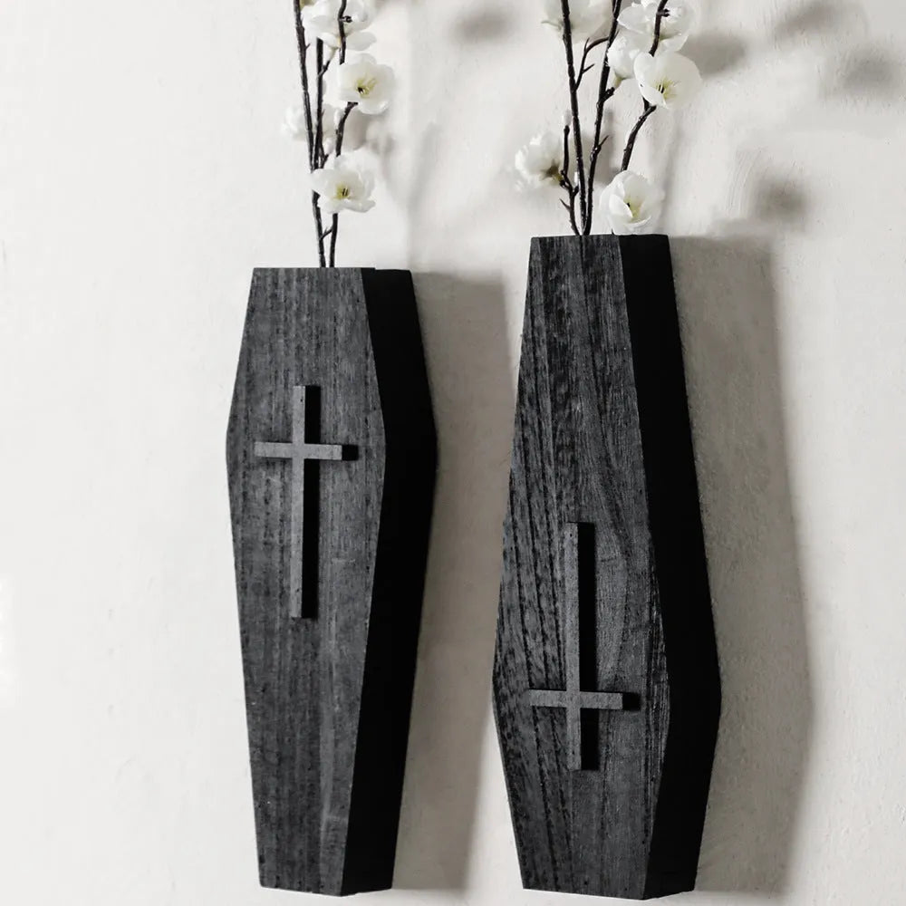 Black cross-shaped wooden wall shelf measuring 27 by 9 centimetres