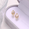 Geometric silver earrings with sweet white crystal studs showing structured design