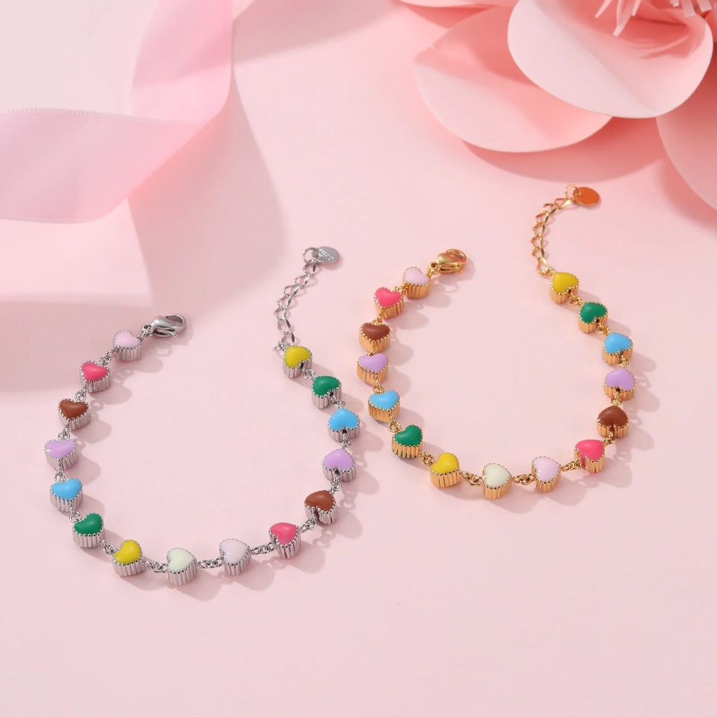 Gold and steel colour heart-shaped titanium steel bracelet on a model's wrist.