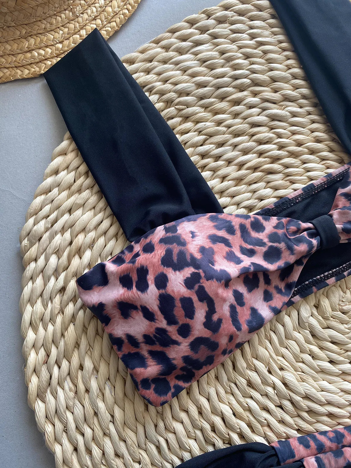 Women's leopard print bikini set with black split tube top and matching bottoms