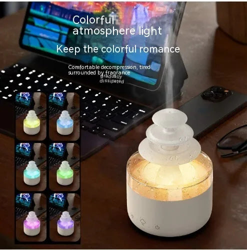 White cloud-shaped humidifier diffuser with multi-colour LED lights on a wooden surface.