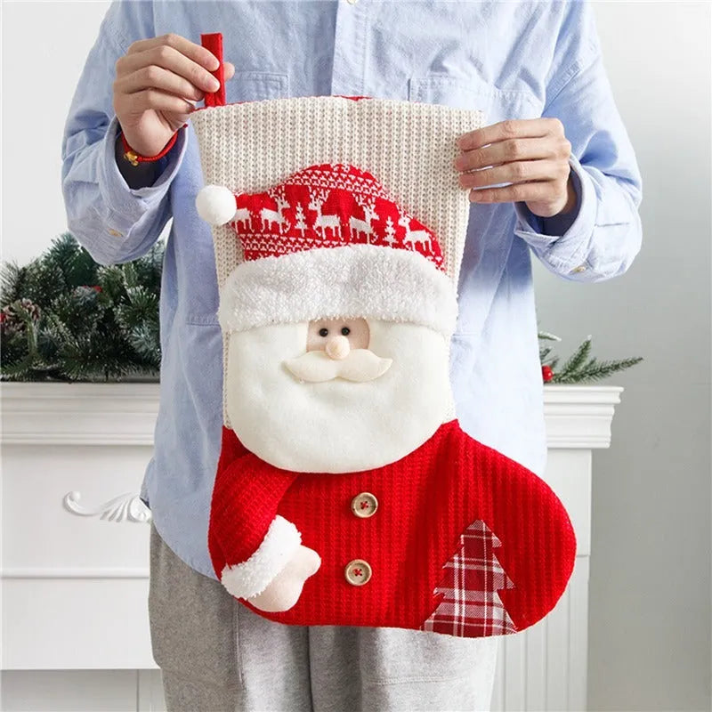 Large red white knitted Christmas stocking with Santa Claus design hanging above fireplace