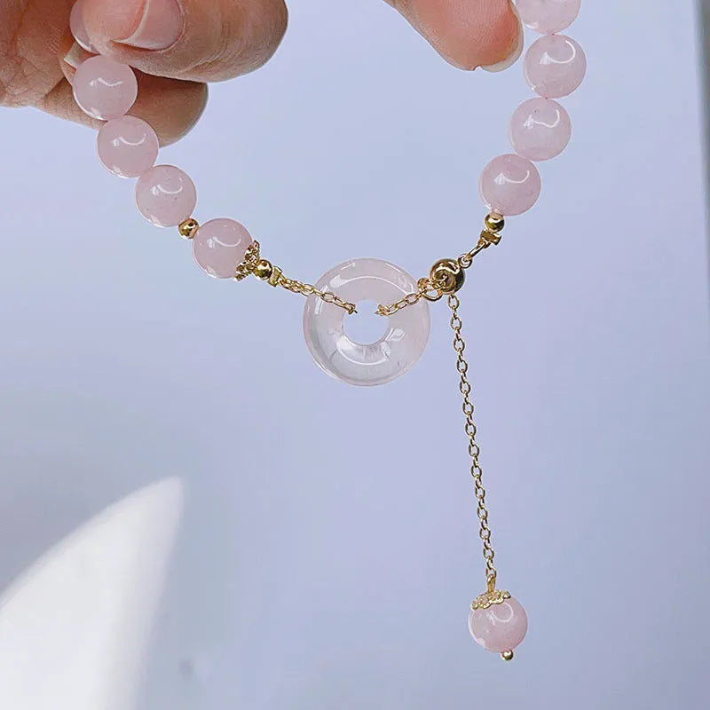 Women's pink crystal bracelet with peace buckle safety closure on wrist