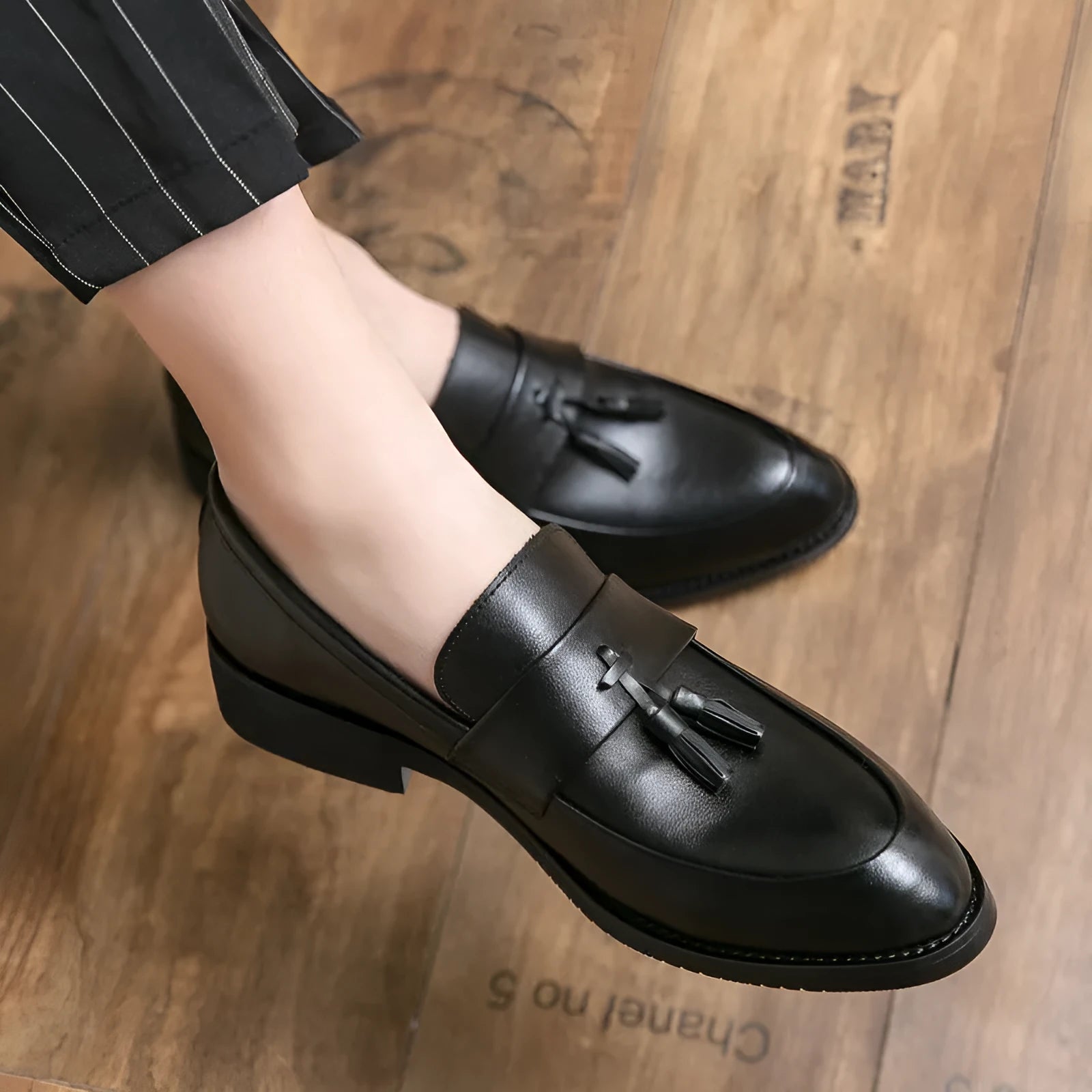 Men's black slip-on business casual shoes with a tassel, made from artificial PU leather with a rubber sole.