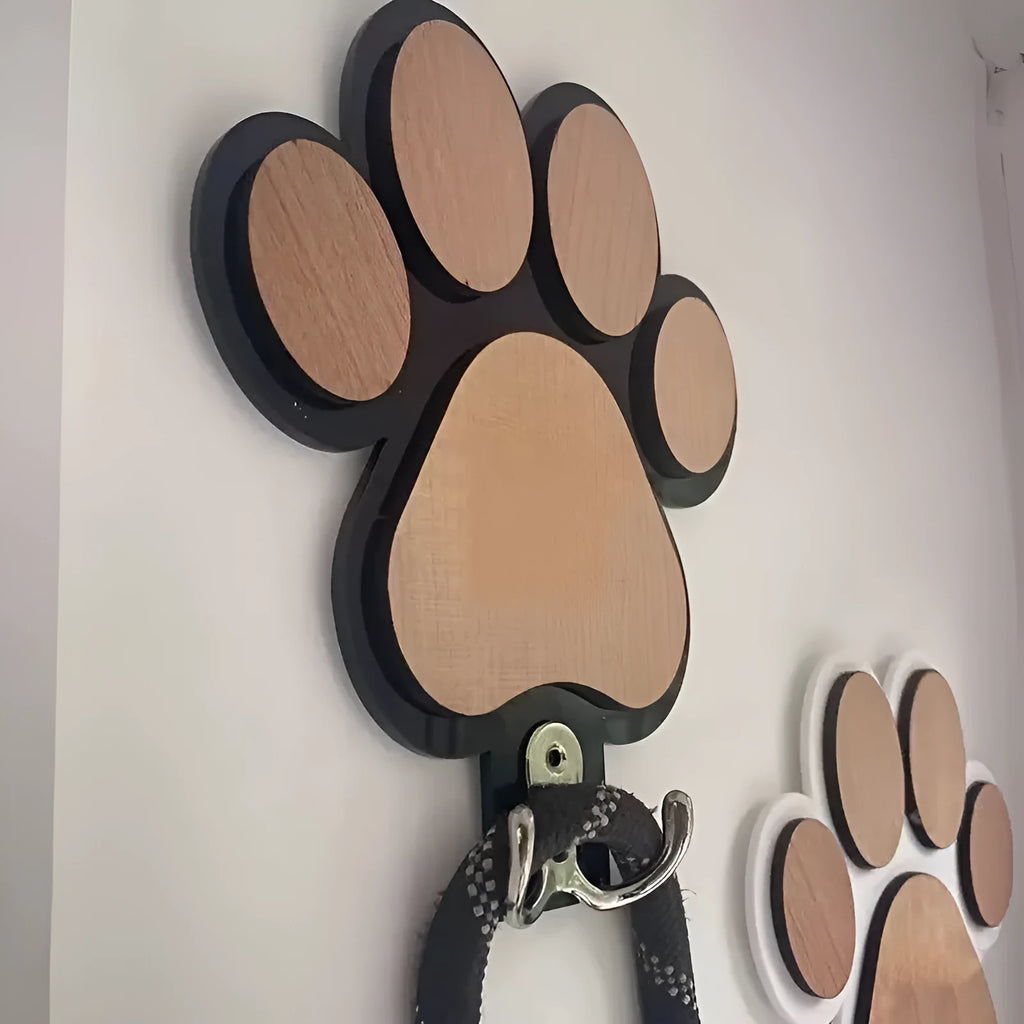 Black wooden wall hook shaped like a paw print for hanging coats and keys