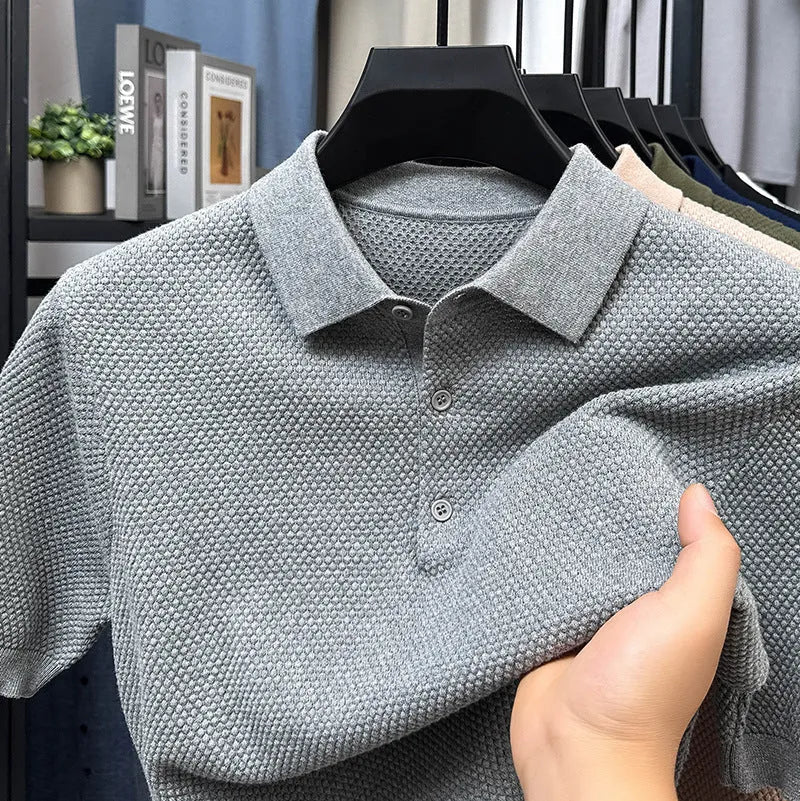 Man wearing a loose navy blue short sleeve cotton pullover sweater casually.