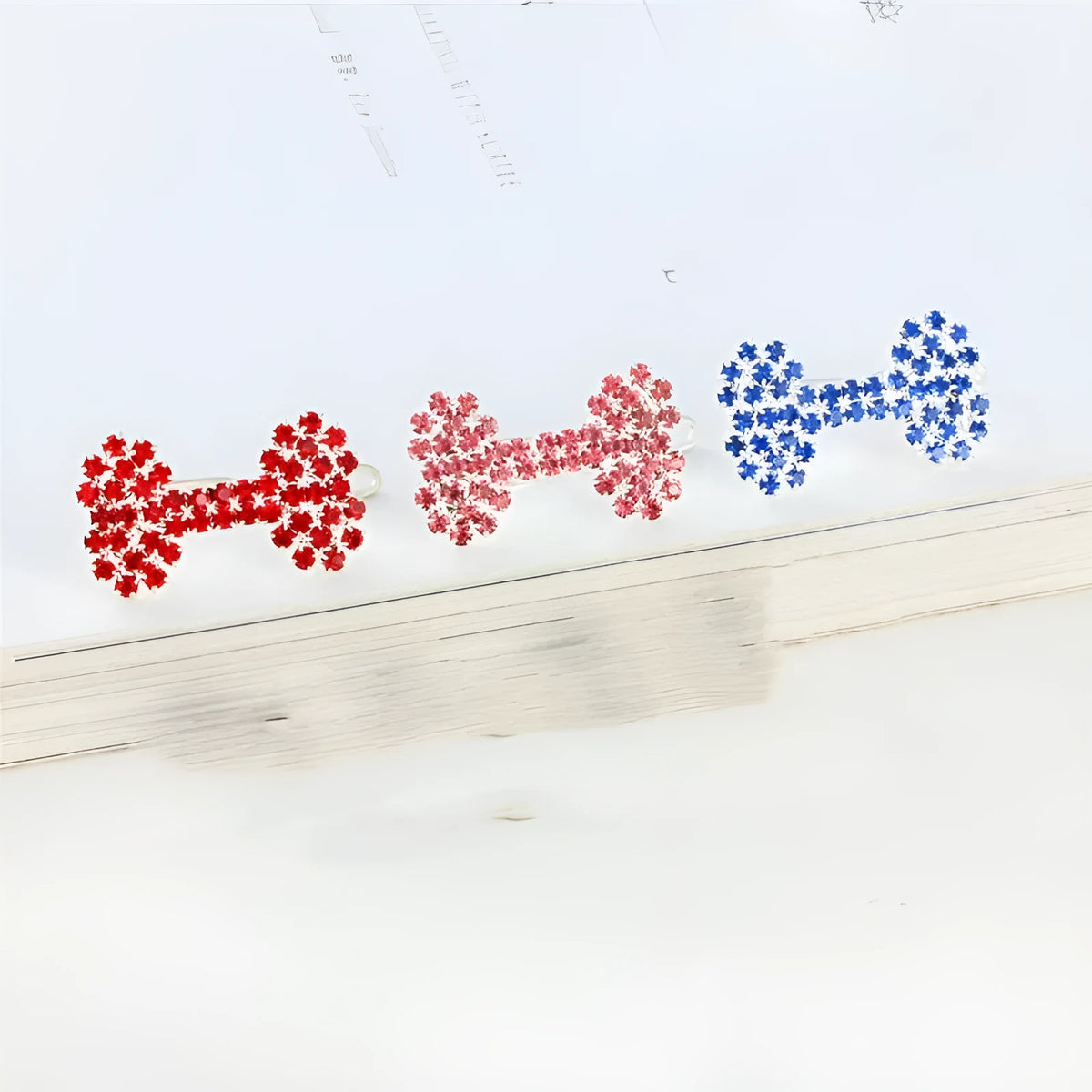 Diamond dog bone pet barrette in size S, shown in white, pink, blue and red for cats and dogs