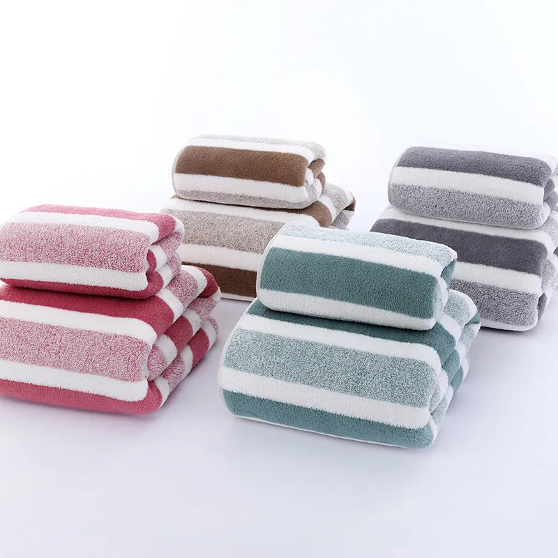 Coral fleece striped bath towel set showing hand towel and bath towel in grey and pink.
