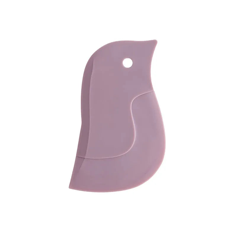 Green penguin-shaped kitchen scraper with soft blade, 11cm by 7cm, for cleaning plates and pots