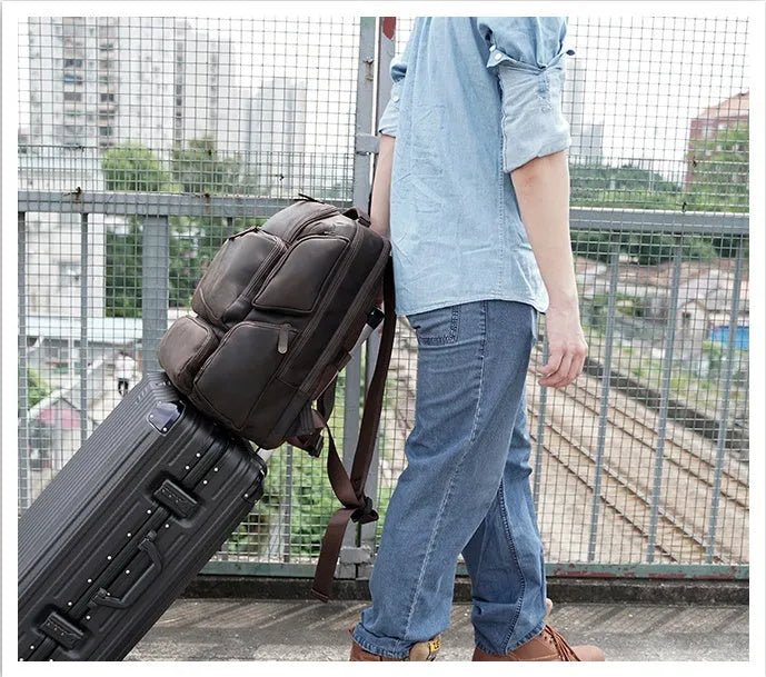 Dark brown genuine cowhide leather backpack with double shoulder straps and organisational compartments for 17-inch laptop